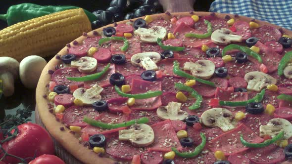 A cooked pizza with various toppings and sesame on a decorated table