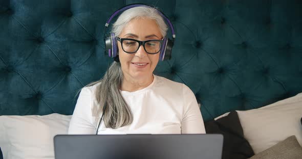 Elderly Woman with Laptop Singing