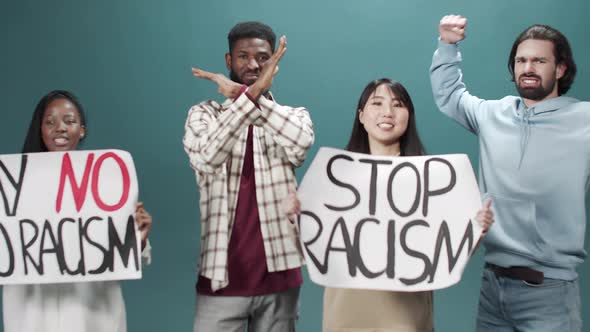 Group of Young Activists Protest Against Discrimination with Stop Racism Poster alt