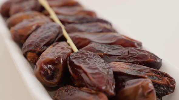 Dried Phoenix dactylifera exotic fruit  packed on white background  slow panning 4K 2160p UltraHD fo alt