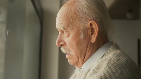 Pensive elderly senior man looking away feel upset, thoughtful melancholy older retired gray haired