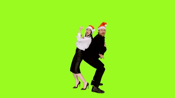 Two Funny Colleagues Dancing While Celebrating Christmas