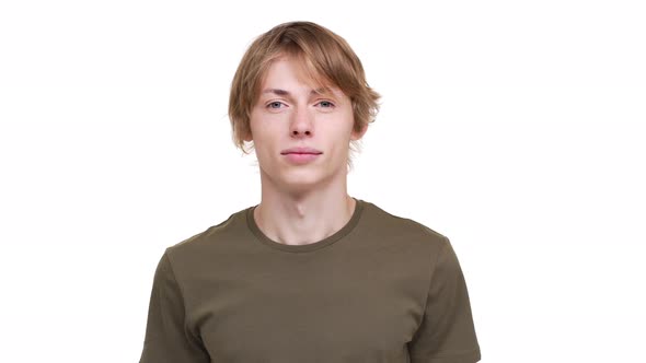 Portrait of Caucasian Guy in Green Tshirt Looking on Camera Being Calm and Glad Being Isolated Over alt