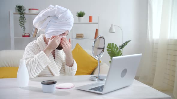 Skin Treatment and Selfcare Concept. Smiling Young Man Applying Eye Mask at Home alt