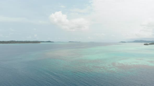 Aerial: flying over tropical island white beach caribbean sea turquoise water co alt