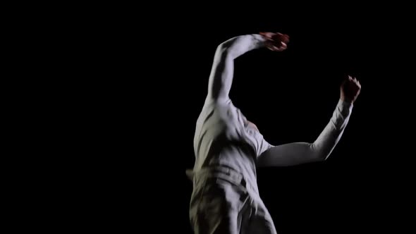 Jump Gymnast Men on a Black Background on a Trampoline. Freedom and Flight alt