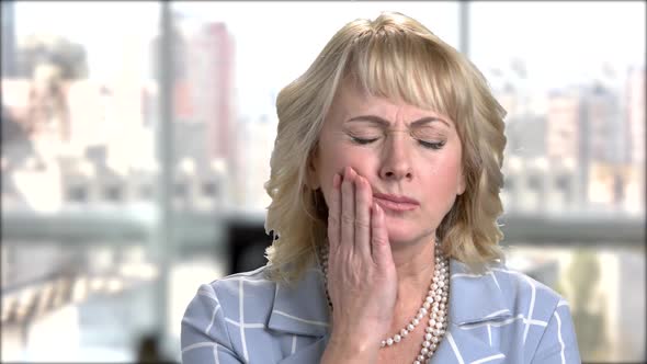 Mature Blonde Suffering From Toothache. alt