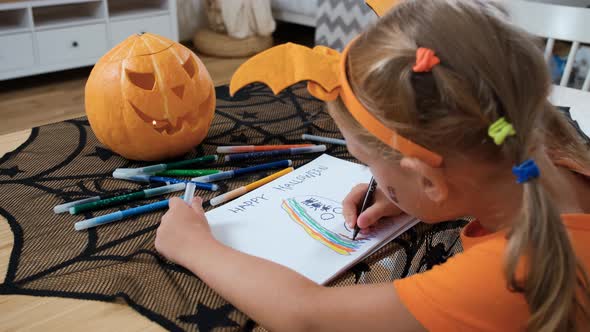 Cute Little Girl Drawing Ghost in Halloween alt