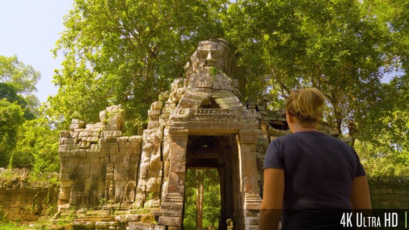 4K Tourist Woman Exploring Khmer Empire Tower Ruins in Cambodia alt