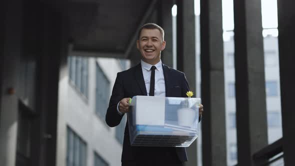 Portrait Happy Male Office Worker With Box of Personal Stuff