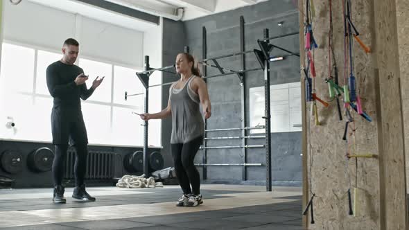 Woman Jumping Rope at Workout with Personal Coach alt