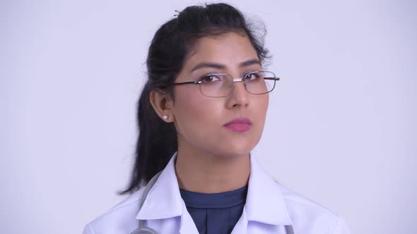 Face of Young Serious Persian Woman Doctor Nodding Head No alt