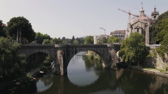Medieval Sao Goncalo Bridge over the Tamega River, Amarante, Portugal. Aerial pullback alt