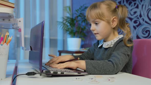 Child Girl Pupil Doing School Homework on Laptop Computer at Home with Teacher Distance Education alt