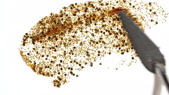 Brushstrokes of Gold Paint Brush Applied Isolated on a White Background alt