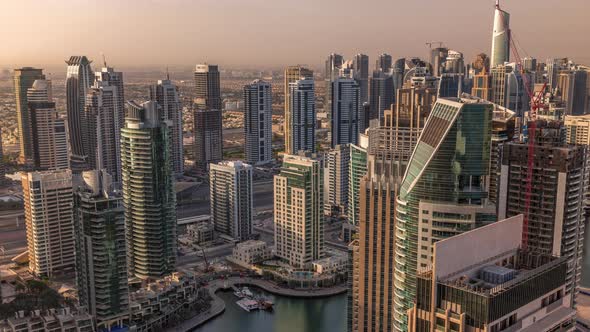 Dubai Marina Skyscrapers and Jumeirah Lake Towers Sunrise View From the Top Aerial Timelapse in the alt