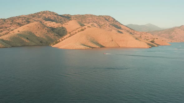 Aerial Drone Tracking Shot of a Boat on a Beautiful Mountain Lake (Lake Kaweah, Visalia, CA) alt