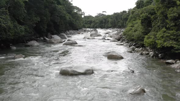 Tropical river in the Andes of Ecuador with large boulders alt