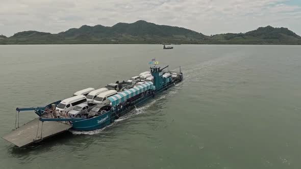 Aerial View of Cargo Barge/Ship Filled with Cars Crossing Lake/River 02