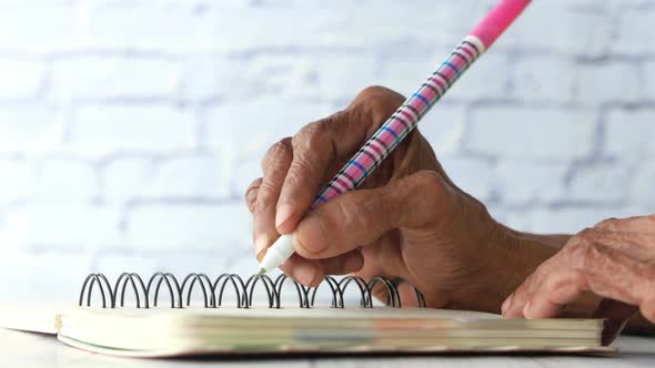 Close Up of Senior Women Hand Writing on Notepad