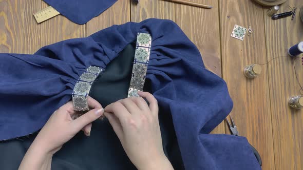Women's Hands Fasten Metal Clasp on Neck of Cloak Mantle