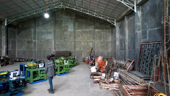 Worker performing quality check on a factory. alt