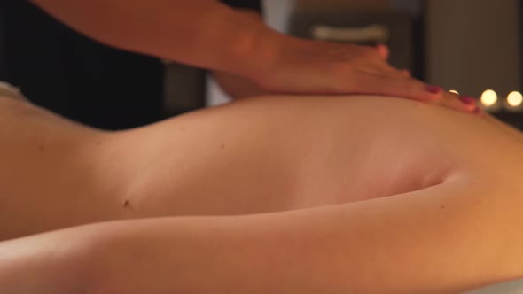 A Woman Gets a Back Massage at a Spa