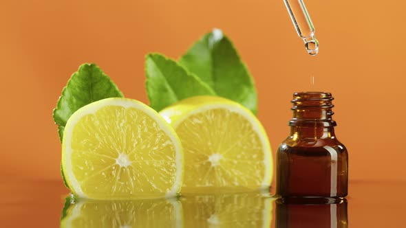 Dripping Lemon Juice From Pipette Into Bottle Closeup Vitamin Oil alt