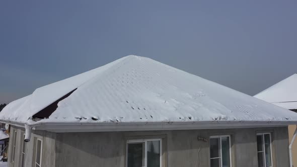 Cottage House Pitched Roof Covered By Snow