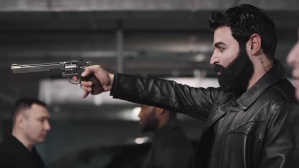 Brutal Man Aiming Gun At Forehead alt