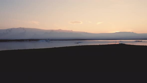 Silhouette Of Man Walking Through Icelandic Landscape alt