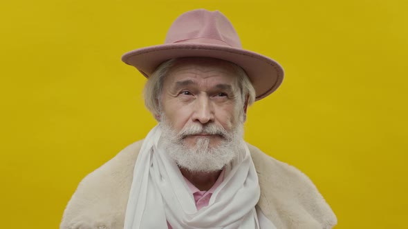 Stylish Old Man In Pink Clothes On Yellow Background alt