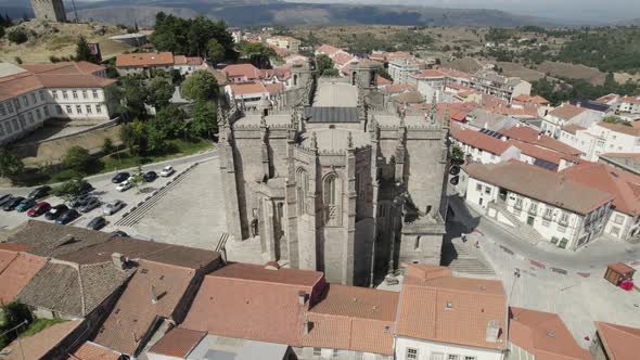 Aerial pullback from Old stone Cathedral revealing beautiful City Landscape of Guarda, Portugal