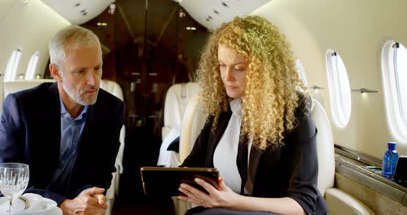 Business people discussing over digital tablet 4k alt