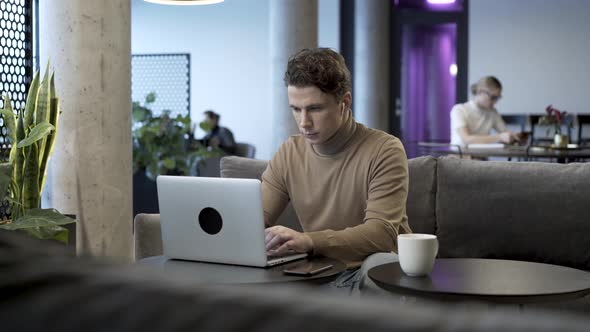 Entrepreneur Working With Laptop In Coworking Space