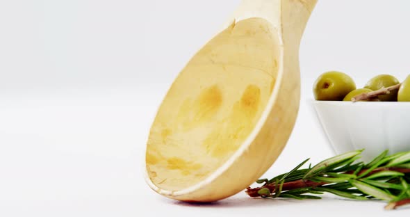 Herbs, green olives and olive oil alt