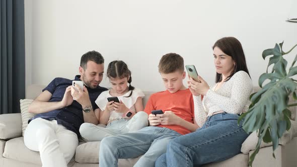 The Family of the European Generation Enjoys Technology Modern Smartphones alt
