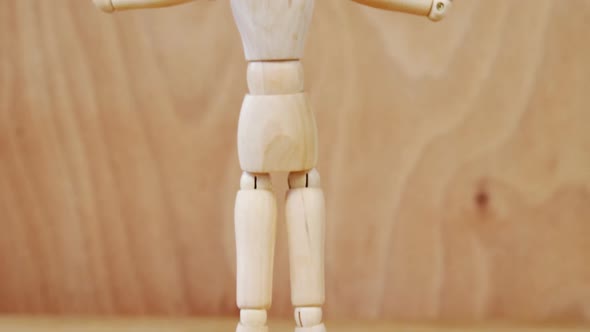 Figurine standing with arms stretched alt