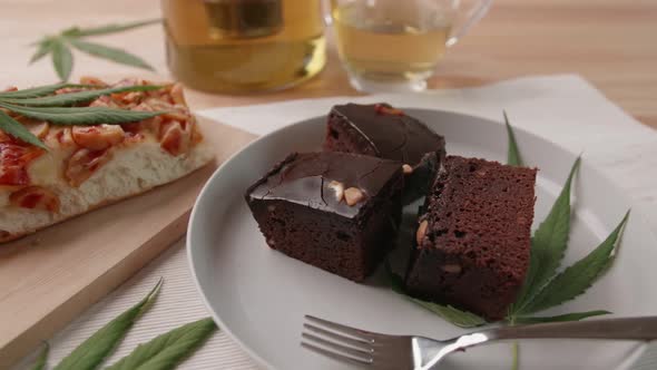 Food and drink and cannabis leaves on the dining table. Alternative medicine concept. alt