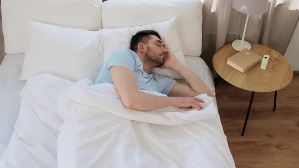 Man Sleeping in Bed at Home