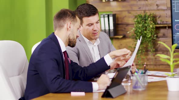 Two Colleagues in Business Suits in the Conference Room alt