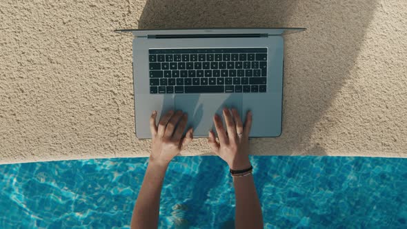 Freelance Female Hands Working on Laptop From Pool alt