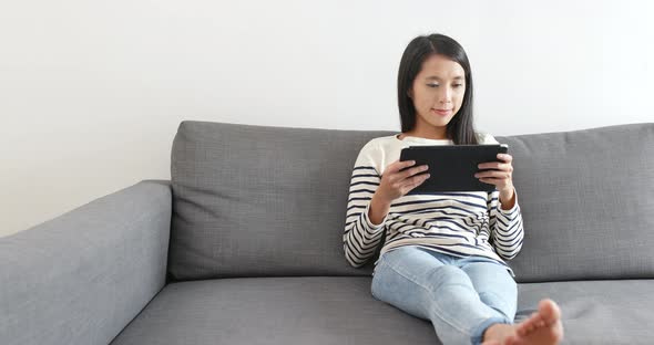 Woman Watching on Tablet Computer alt