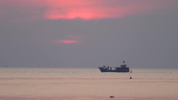 Cinematic View of Fisherman's Boat Travelling in the Ocean on a Dramatic Dusk alt