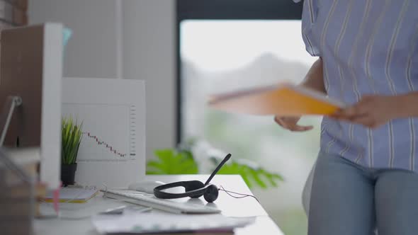 Confident Beautiful Woman Entering Home Office Sitting Down at Computer Table and Putting on alt