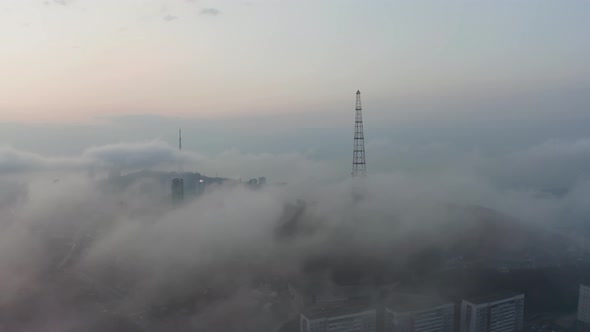 Drone View of the City Covered with Fog at Sunset alt