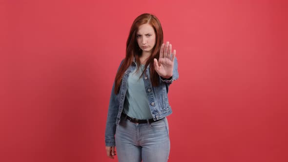 Young Woman Making Stop Gesture with Her Hand alt