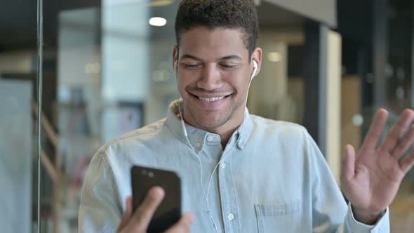 Dancing Joyful Young African Man Listening Music on Headphones alt