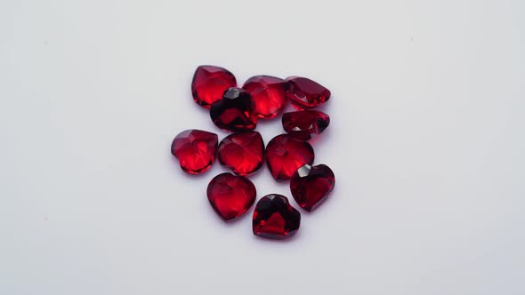 Natural Red Garnet Gemstone on the White Background on the Turning Table alt
