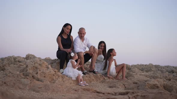 Wide Shot of Happy Joyful Daughters and Confident Couple of Parents Talking Admiring Beauty of alt